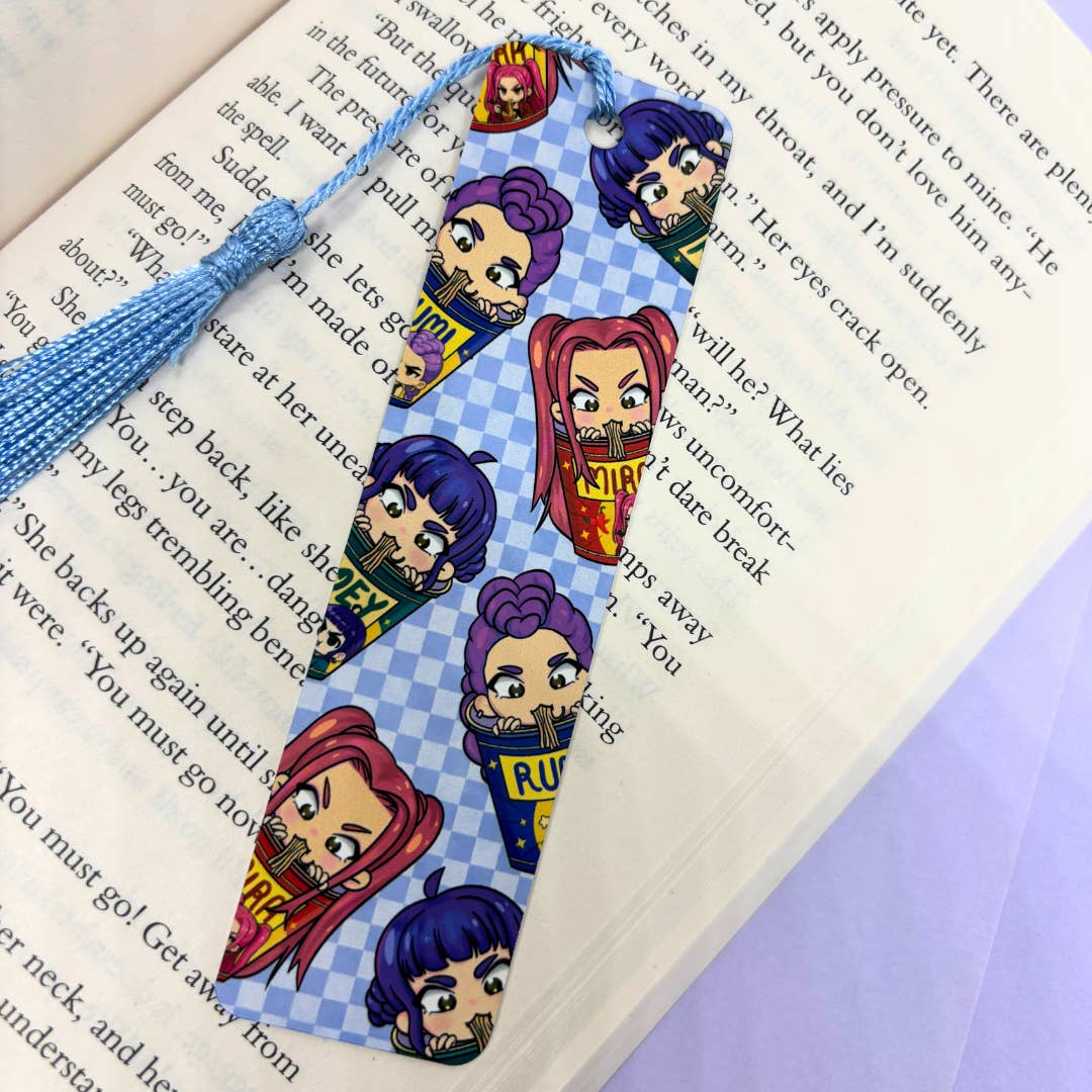 Bookmark with demon hunters cartoon characters on a book page