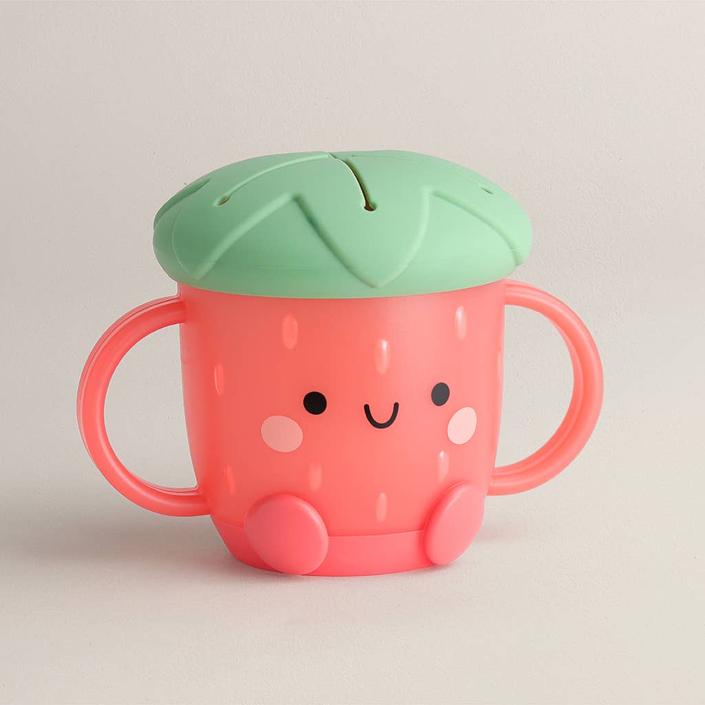 Pink cup with green lid on a beige background