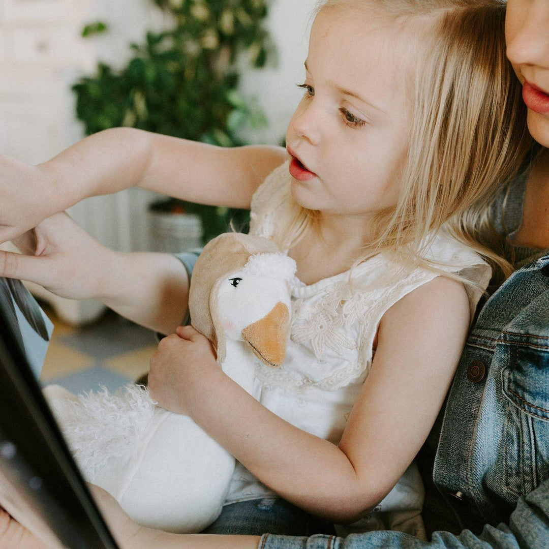 little girl holding the plush goose