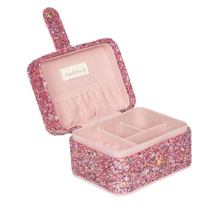 pink glitter jewelry box with snap closure. pocket when you open it on the top and a place for rings and earrings. different dividers