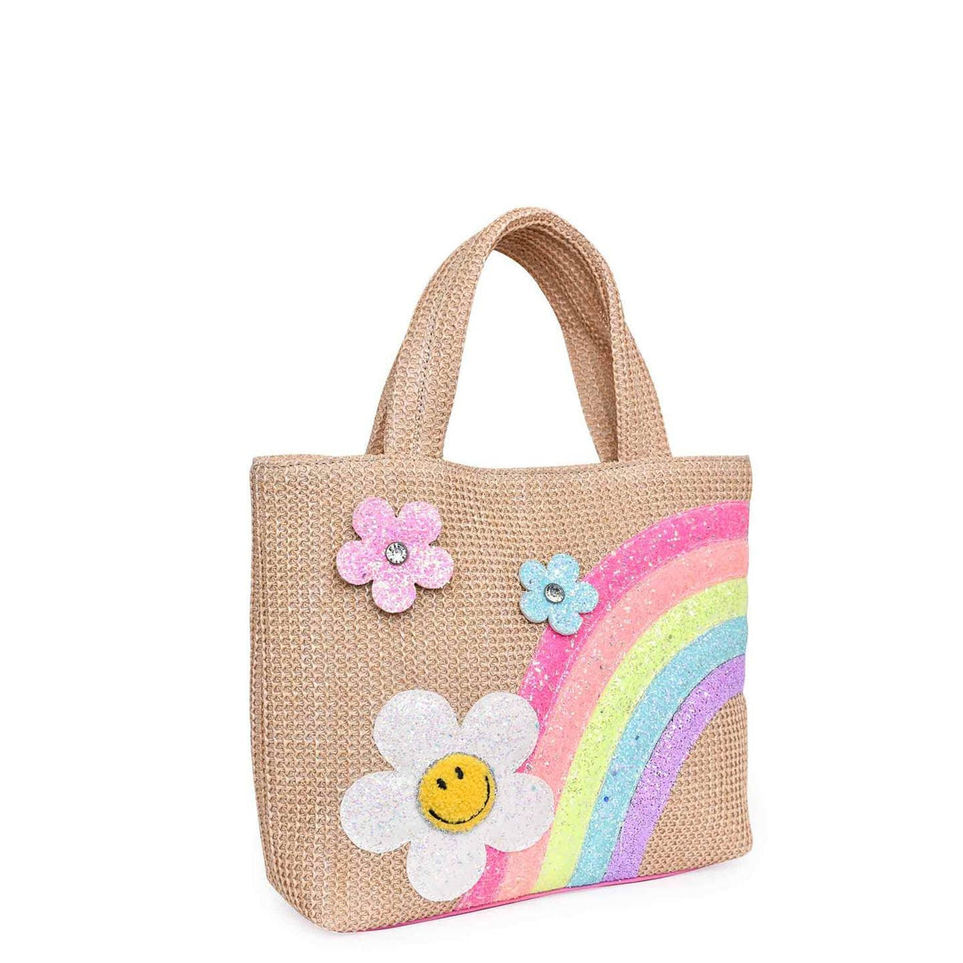 small straw tote with rainbow on it, two small flowers and one daisy with a smiley face in the center. 