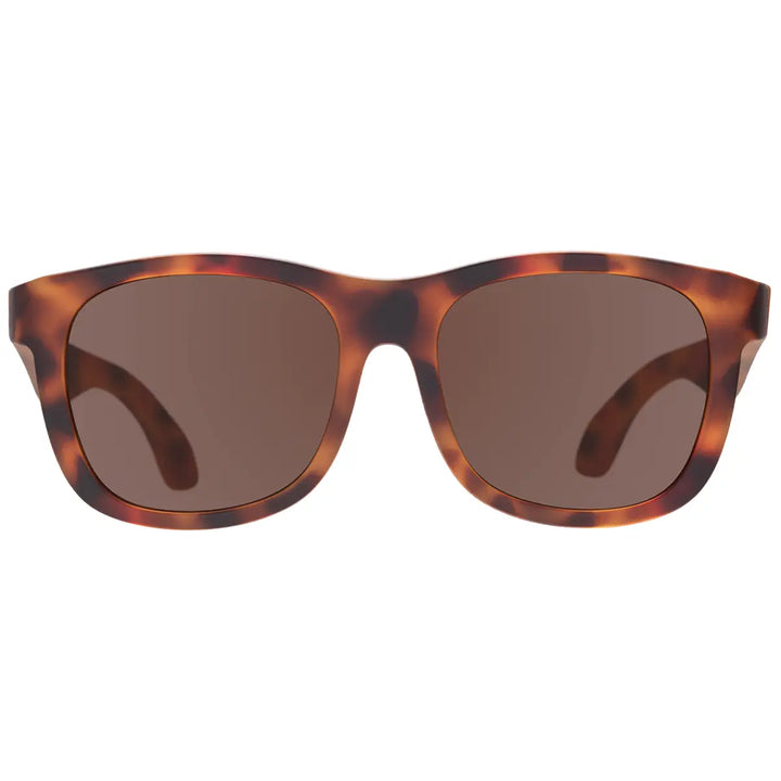 Sunglasses with tortoiseshell frame and brown lenses on a white background