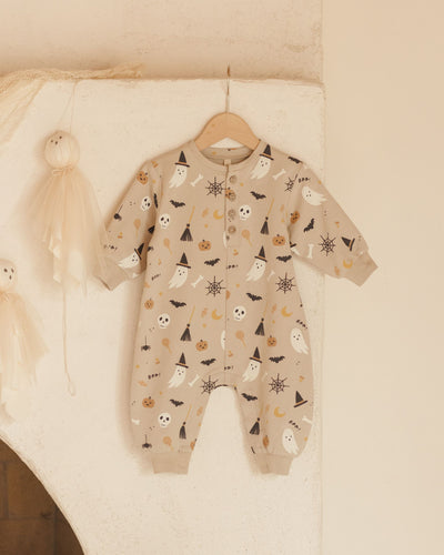 baby jumpsuit hanging up on a hanger, can easily see the Halloween print in this picture. 