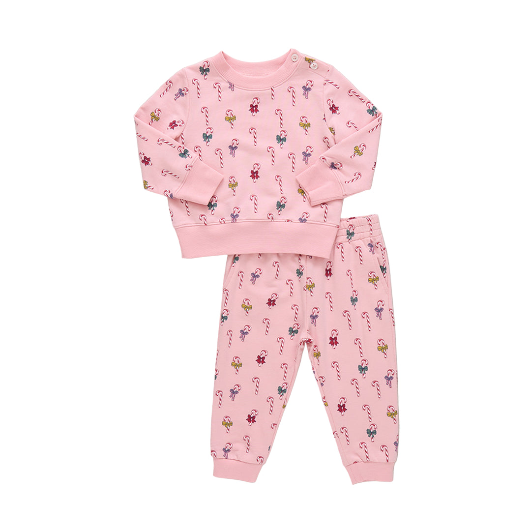 Pink jogger set with candy cane pattern on a beige background