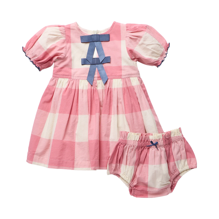 A baby girl's two-piece outfit featuring a short-sleeve dress and matching bloomers in a pink and white gingham check pattern, accented with a blue bow at the neckline and on the waistband.