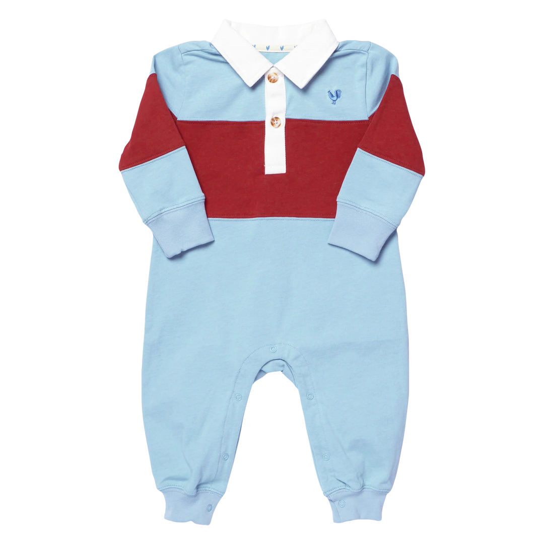A baby long-sleeve colorblock romper in light blue, burgundy red, and white, featuring a white collar with two decorative buttons and a small embroidered blue rooster logo on the chest.