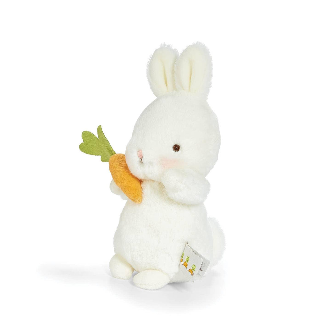 small plush bunny holding a carrot and standing to the side on an angle 