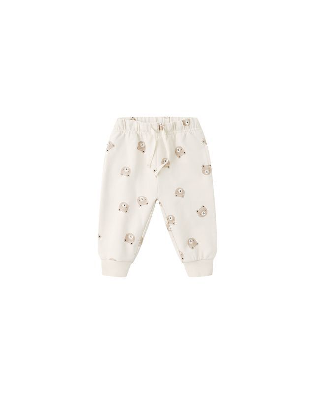 cream baby joggers with small bear heads printed all over the pants 