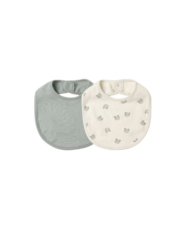 Two baby bibs, one gray and one creme with a small bear pattern, on a white background.