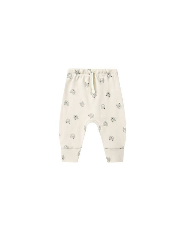 Baby pants with a subtle bear pattern on a white background