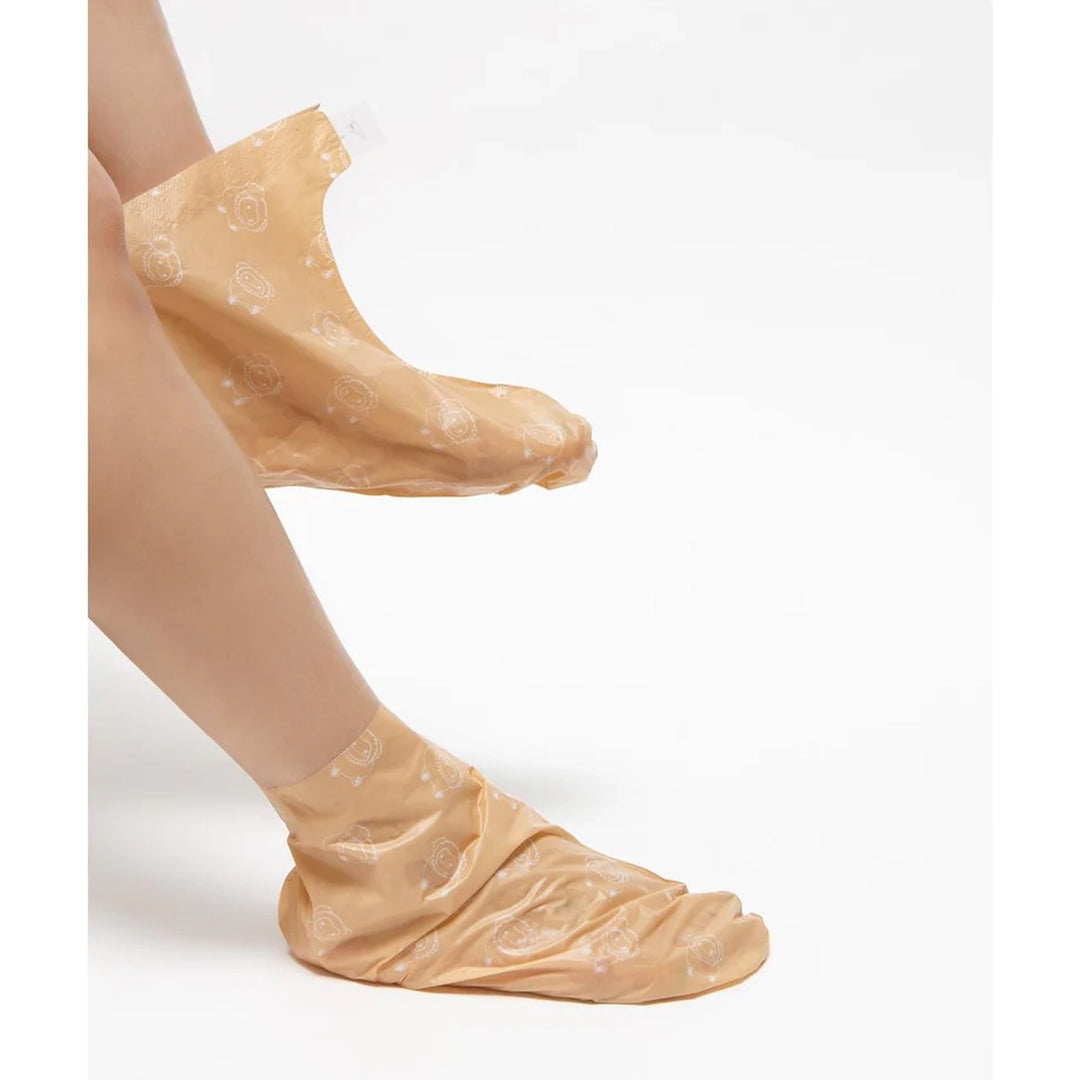 Beige socks with floral pattern worn by a person on a white background