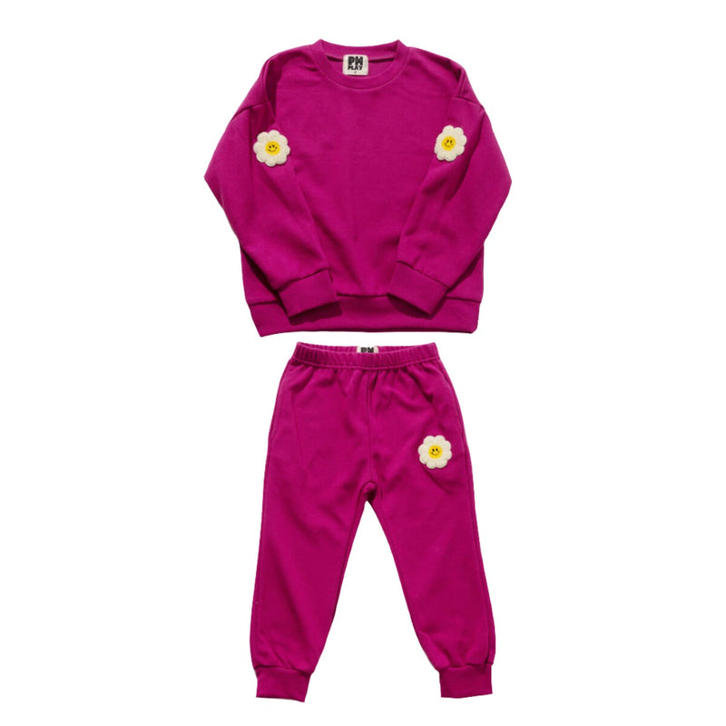 raspberry colored 2 piece sweat set. the sweatshirt has daisy patches on the elbows and pants have a daisy patch on one leg. 