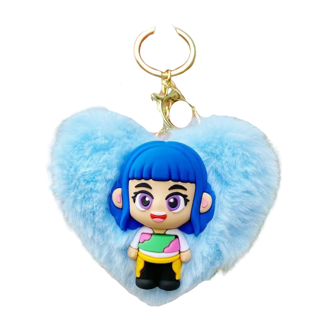 Keychain with a character wearing blue hair and a fluffy heart-shaped attachment held by a hand.