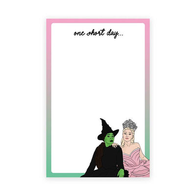 white notepad with green and pink border and Elphaba and Glinda sitting in the corner of the notepad. 