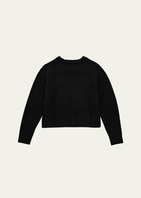 Black sweater on a light beige background
