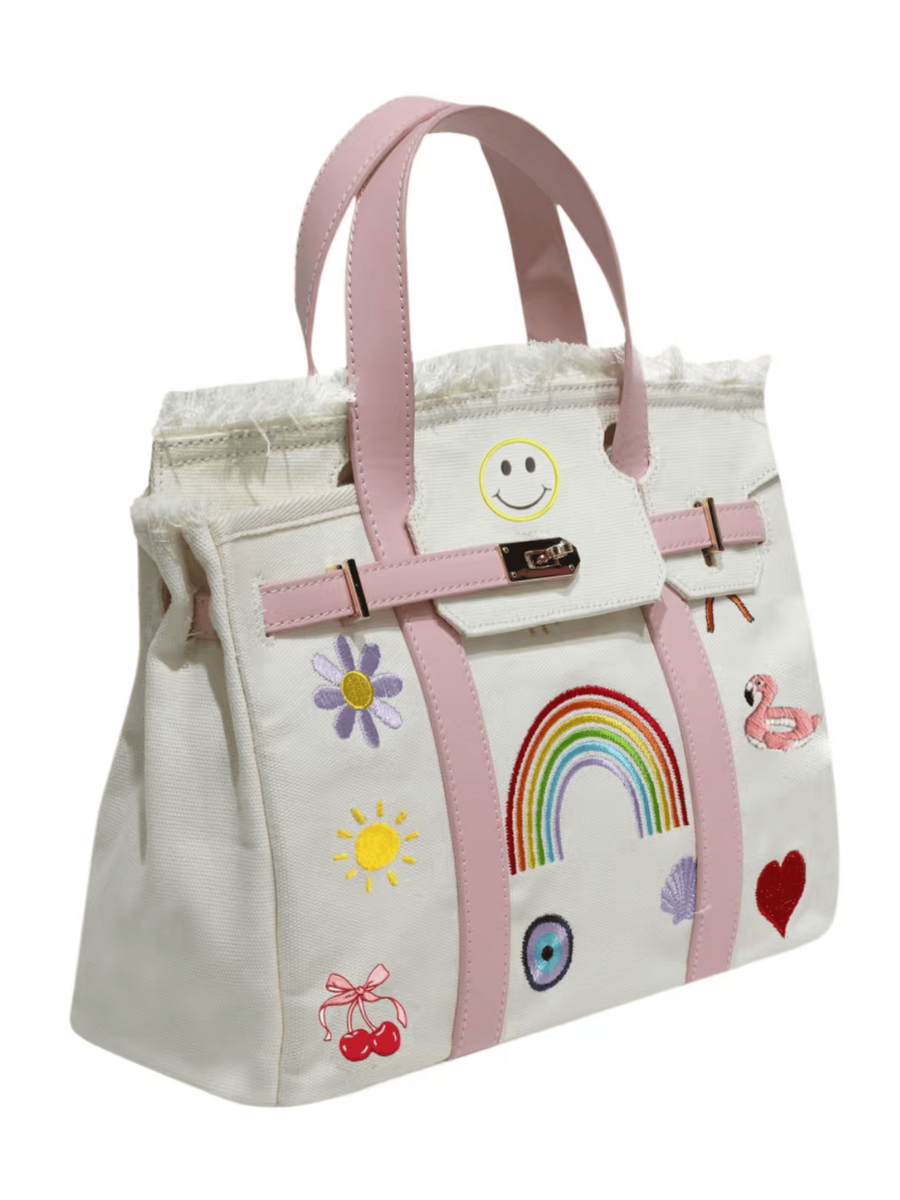 White tote bag with colorful embroidered designs on a white background