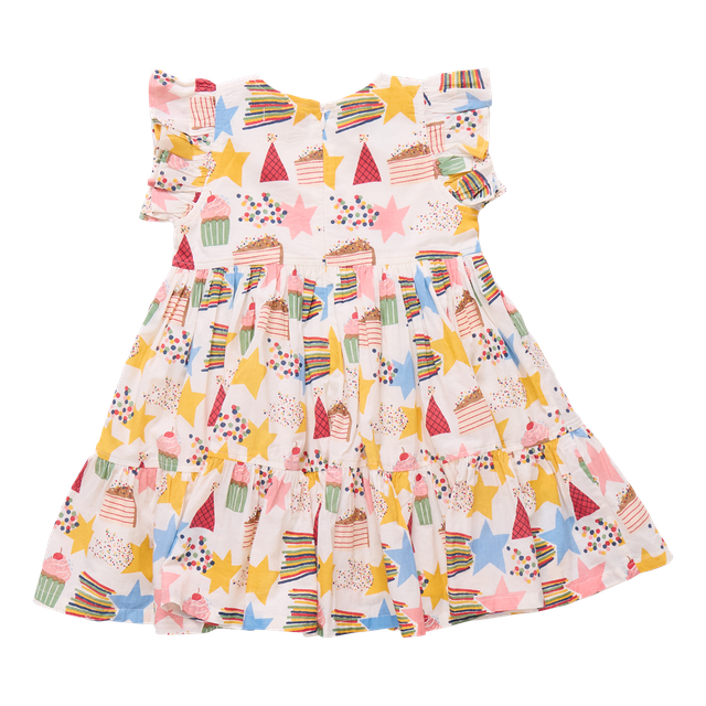 Colorful children's dress with star and cake pattern on a white background