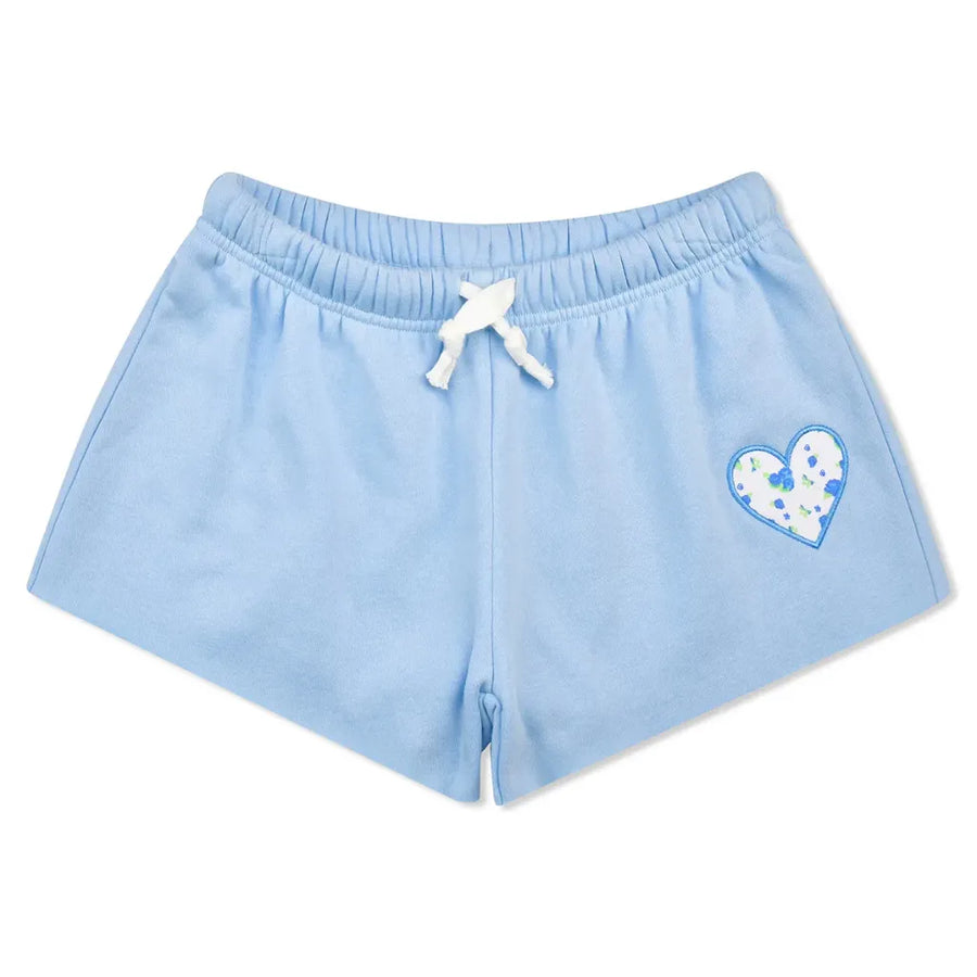 Light blue sweat shorts with a white drawstring and a blue and white patterned heart on the left leg, shown against a plain white background.