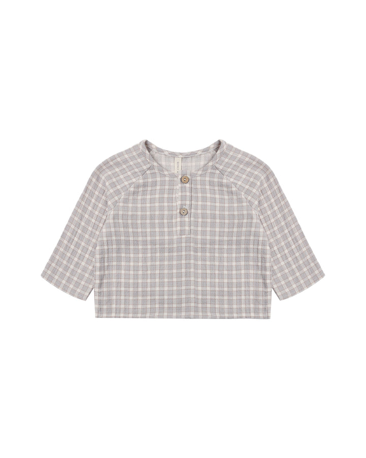 A short-sleeve children's henley top with a light gray and white plaid pattern, featuring a buttoned placket and three wooden buttons, displayed flat against a white background.