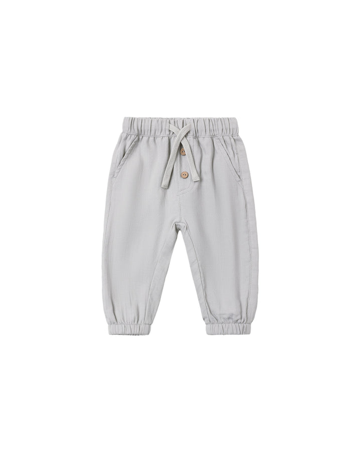 A pair of light gray jogger pants for toddlers, featuring an elastic waistband with a drawstring, side pockets, and elastic cuffs at the ankles, shown against a plain white background.