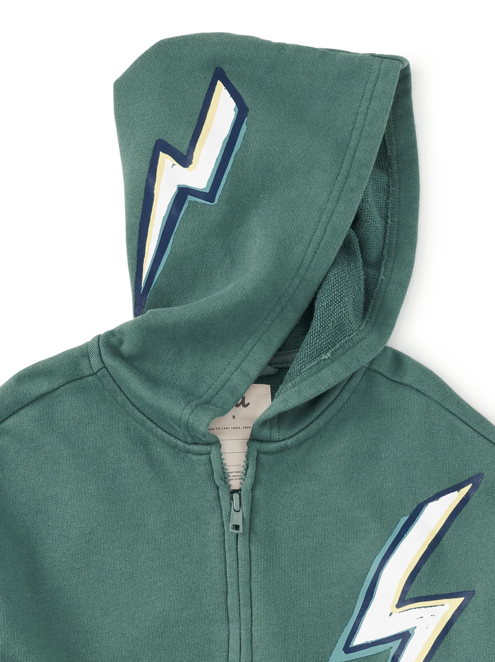 A close-up of a green zip-up hoodie featuring a large white, yellow, and navy blue lightning bolt graphic on the hood and lower front.