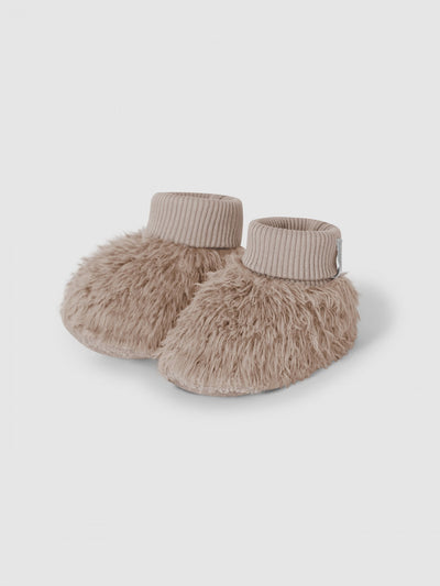 set of baby booties that appear furry but are made of organic cotton. fold over cuff. taupe color. 