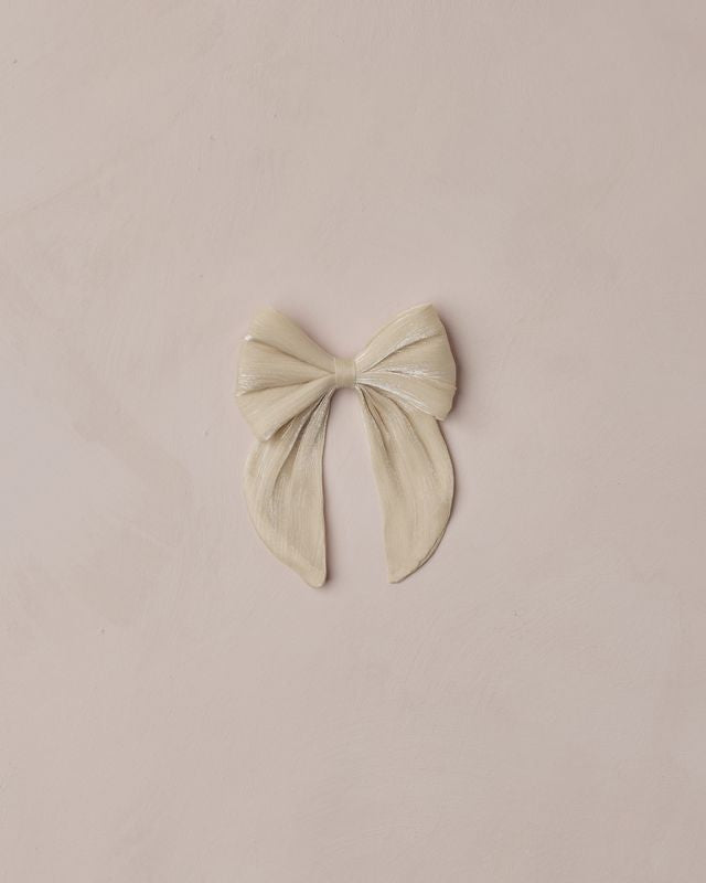 Beige bow hair accessory on a beige background