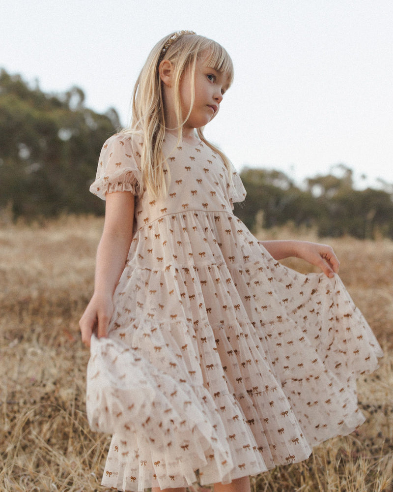 little girl modeling the tulle dress with the tiny bows all over it. 