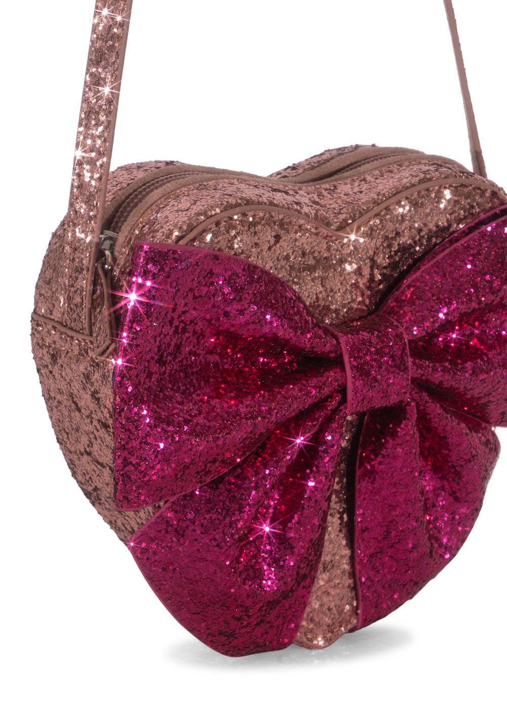 close up of the heart shaped bag with big pink bow on the front. 