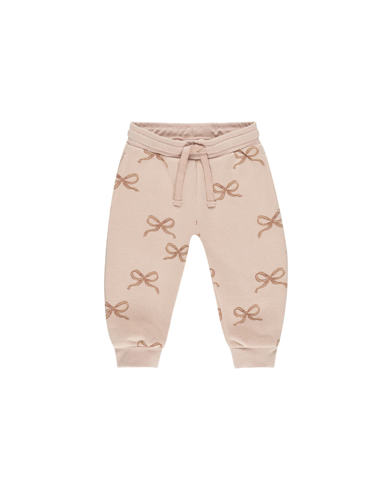 dusty rose joggers with cinnamon bows all over print on the joggers. 