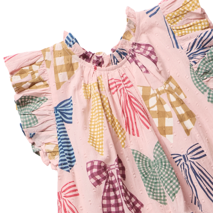 A close-up of a pink children's dress with a bow and gingham pattern, featuring ruffled short sleeves and a gathered neckline.