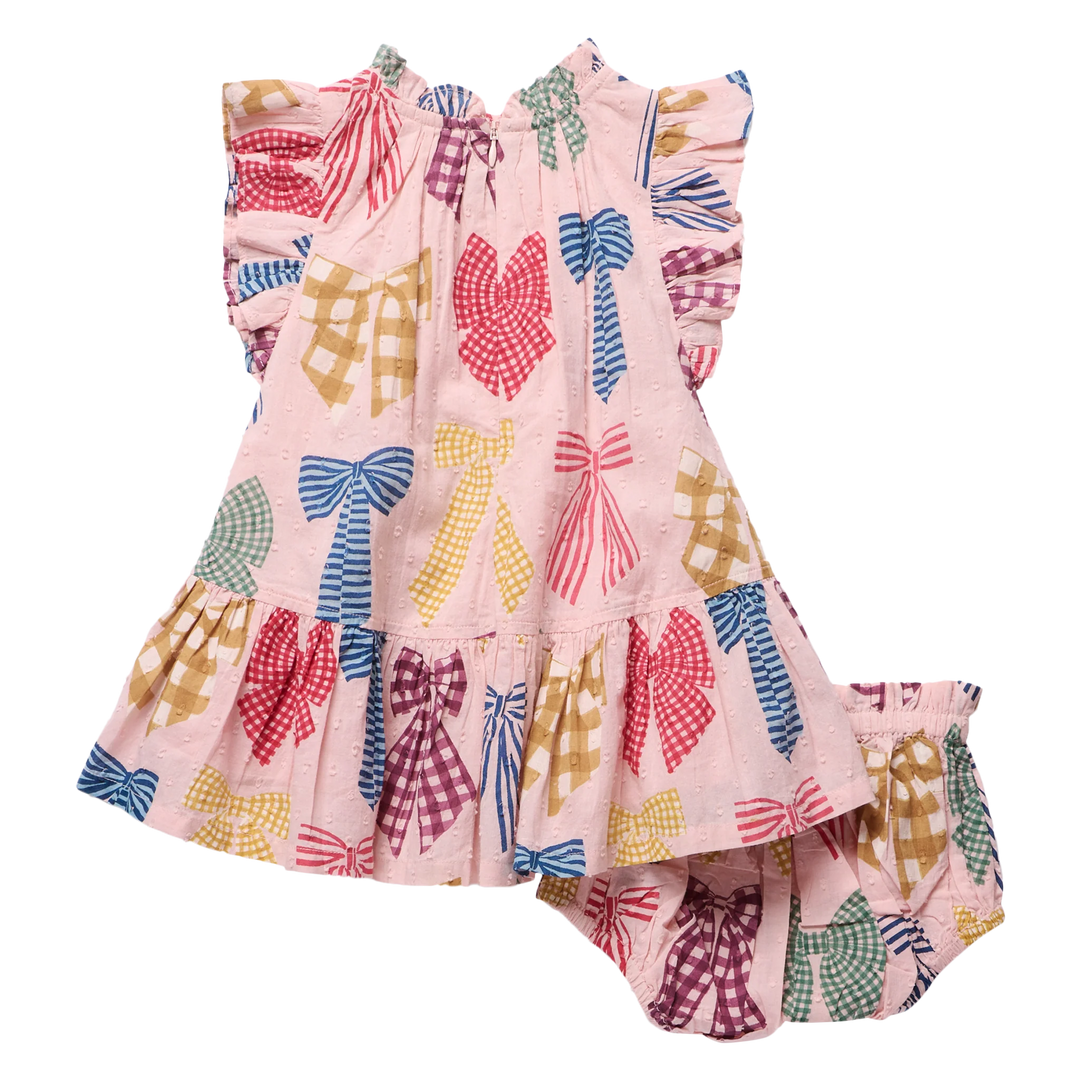 A toddler girl's two-piece outfit set consisting of a sleeveless ruffle-sleeve dress and matching bloomers, both in light pink with a colorful pattern of gingham and solid bow motifs in red, blue, yellow, green, and purple.