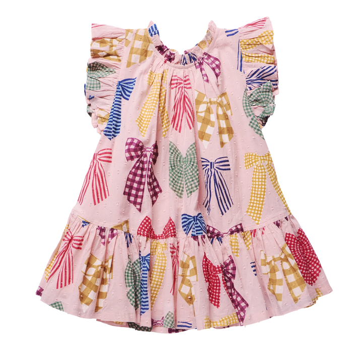 A pink sleeveless dress for toddlers or girls, featuring a playful print of colorful ribbon bows in various patterns (stripes, gingham, polka dots) on a solid white background.