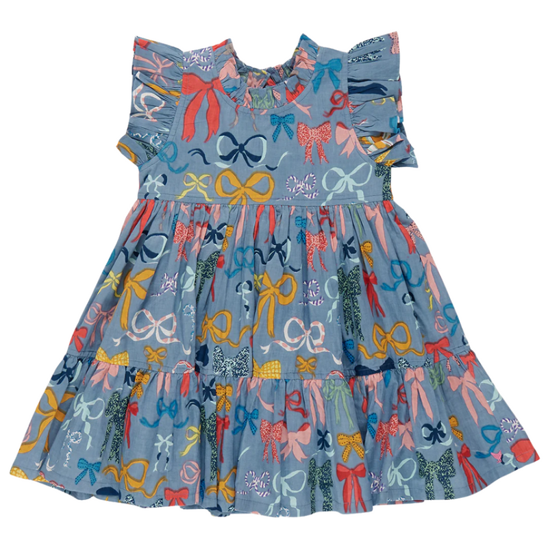 The front of the dress, full skirt and sleeveless design with ruffles on the sleeves. The dress has a blue ground with mutlcolored bows all over it. 