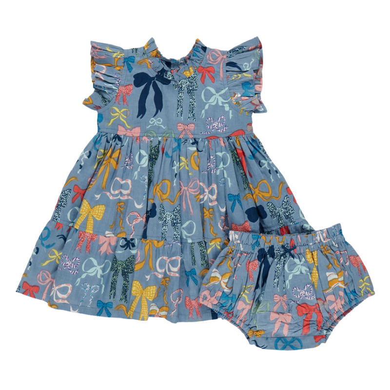 dress has a blue background color, with multicolor bows all over the dress. The bows are yellow, pink, red, orange and navy. The dress also comes with a matching diaper cover in the same print. 