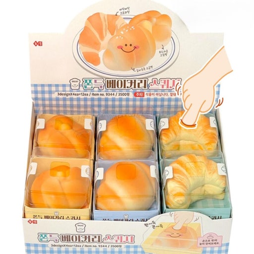 Display box of bread-shaped squishies with a cartoon hand on a white background