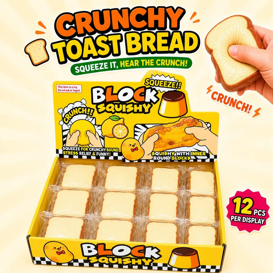 A display box of Block Squishy Crunchy Toast Bread with a hand holding a crushed slice on the right. The packaging is bright yellow and cartoonish, and the box contains multiple wrapped square bread pieces.