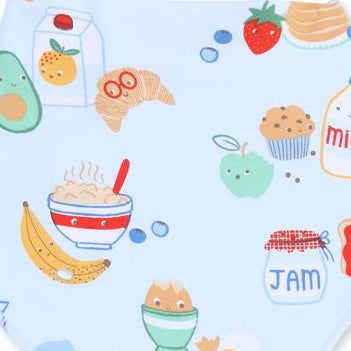 close up of the print. Blue background with cereal, croissants, muffins and juice with faces on them. 
