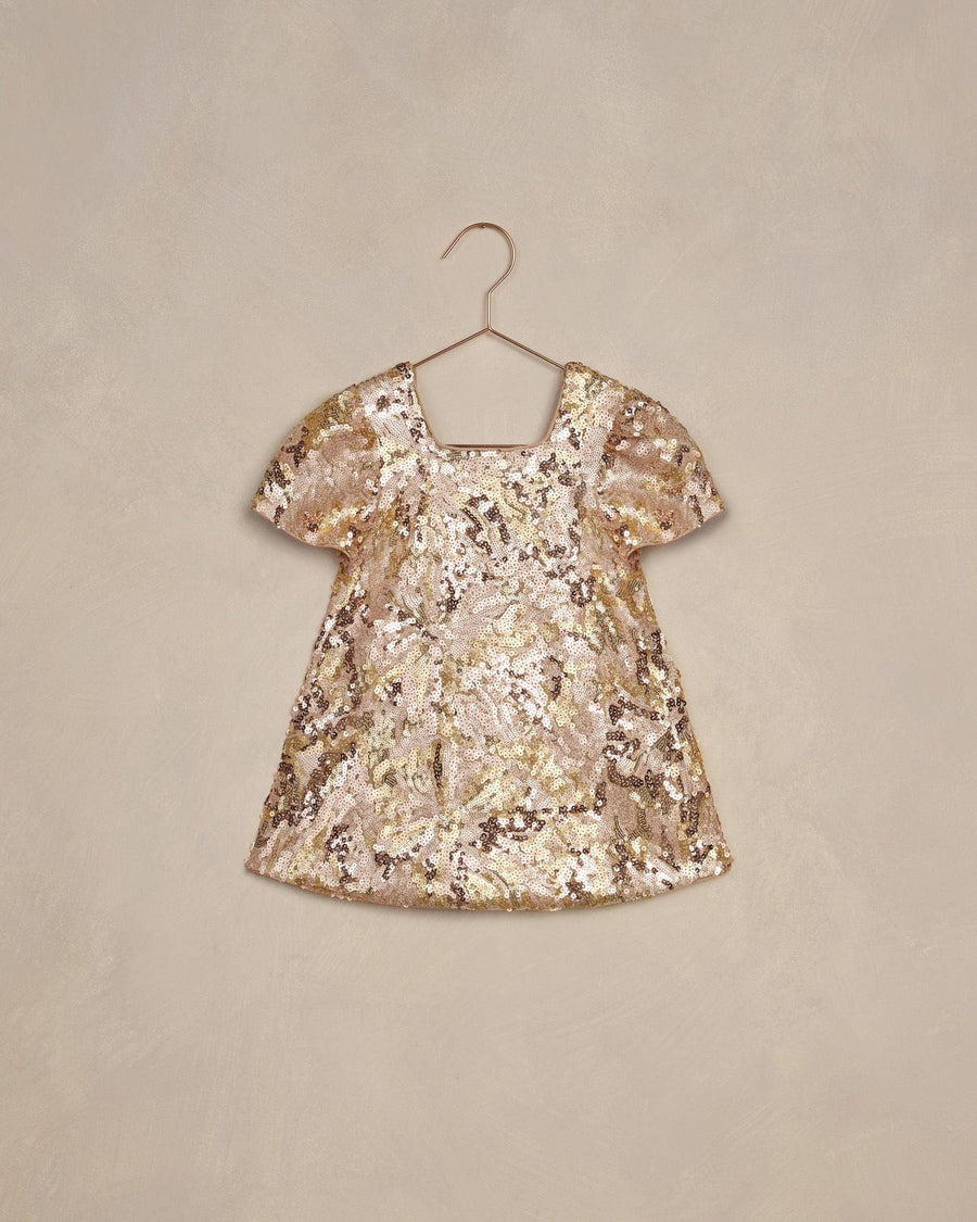 girls dress covered in gold and rose gold sequins