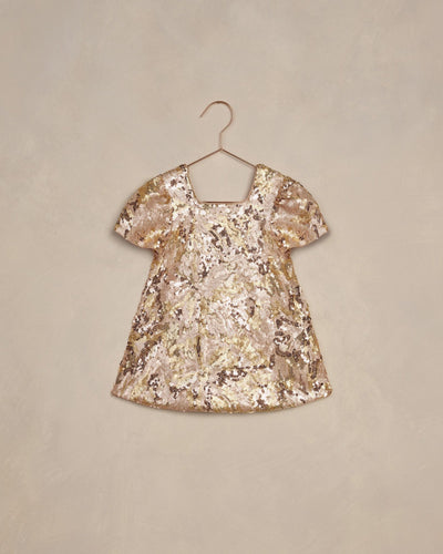 girls dress covered in gold and rose gold sequins