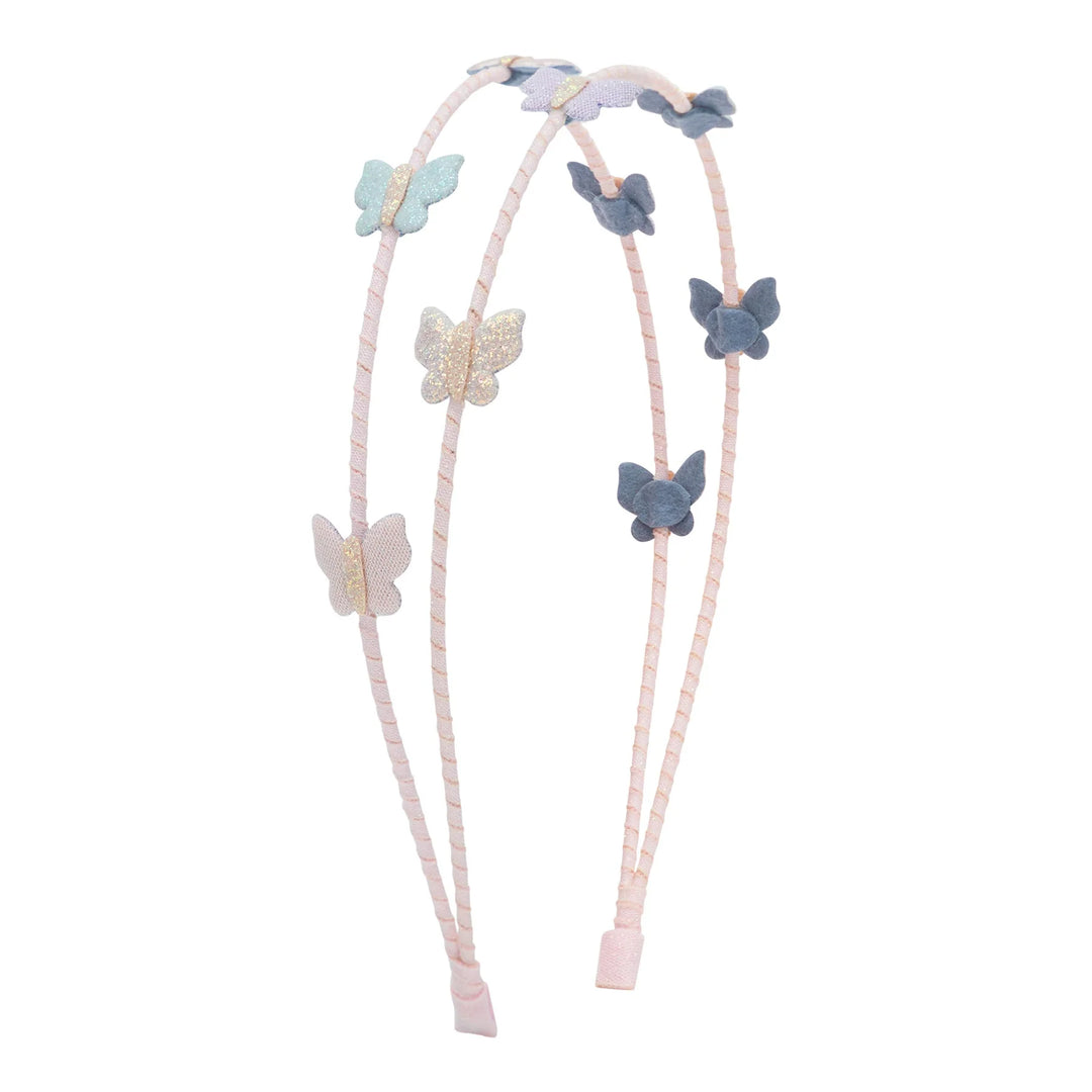 A double-strand light pink braided headband featuring decorative fabric butterfly charms in pastel blue, lavender, and glittery gold, shown against a plain white background.