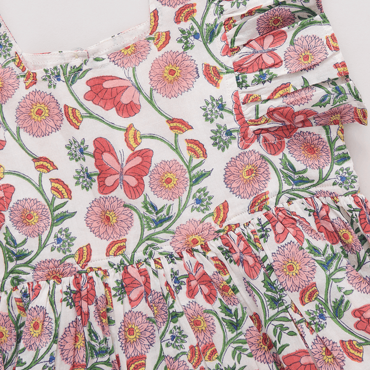 close up of the butterfly vines print. pink flowers, deep pink butterflies and little green and yellow flowers 