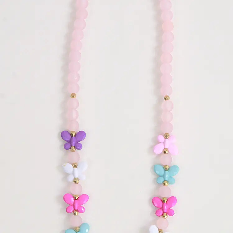 Necklace with pink beads and colorful butterfly charms on a light background
