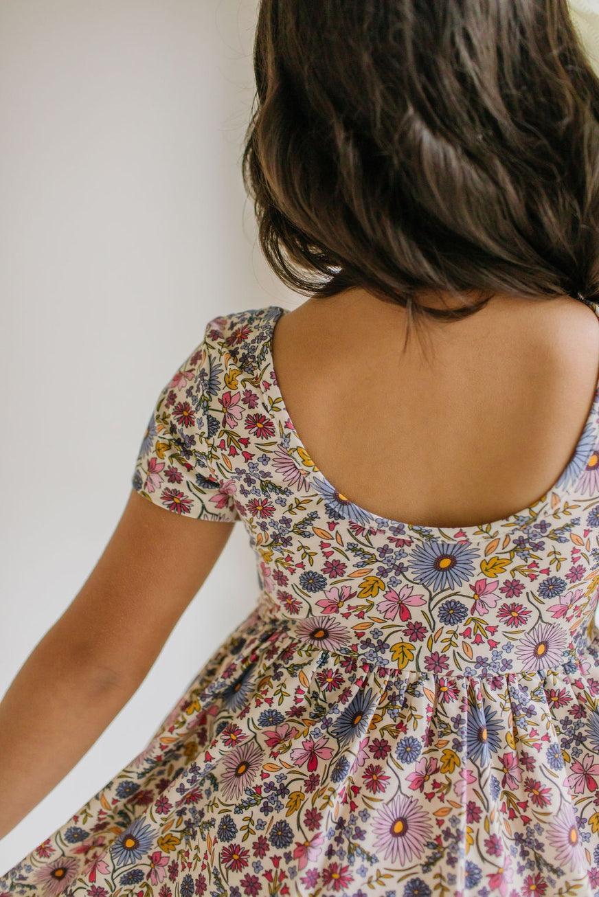close up of the ballet back of the dress with pretty blue, purple and lavender florals 