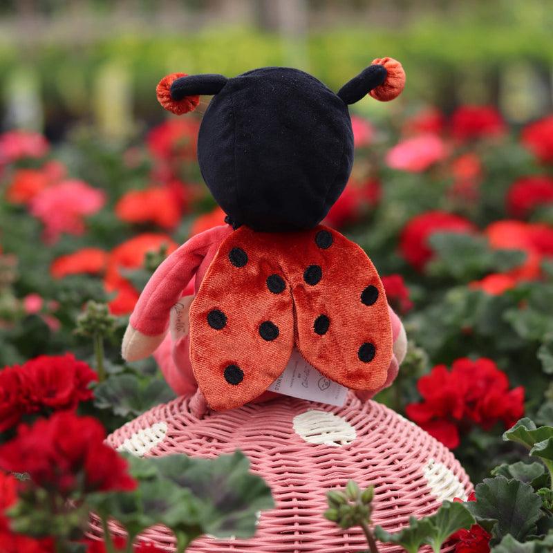 this picture shows the back of the ladybug and her adorable wings in a flower bed. 