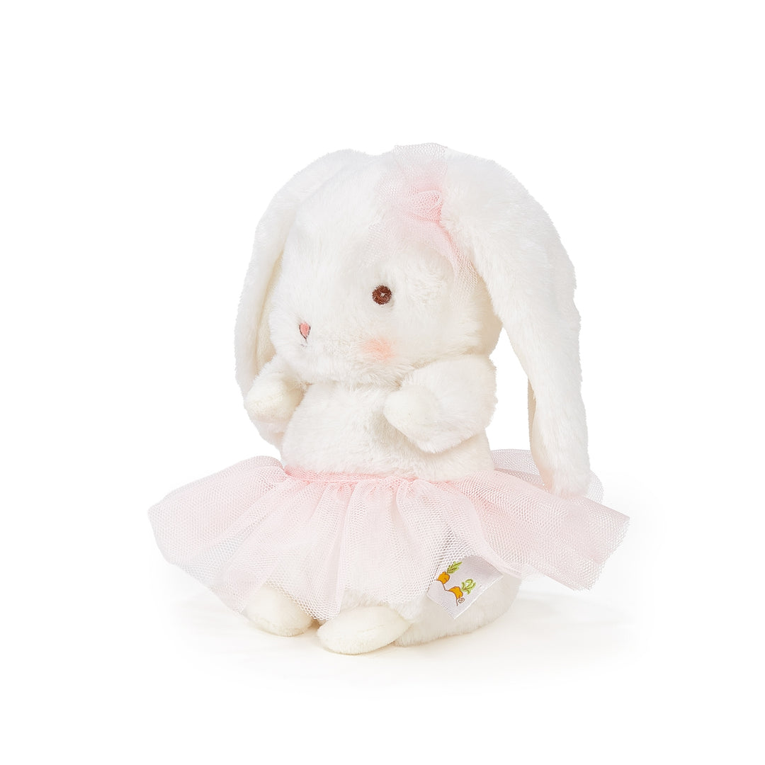 Plush toy rabbit in a pink outfit on a white background