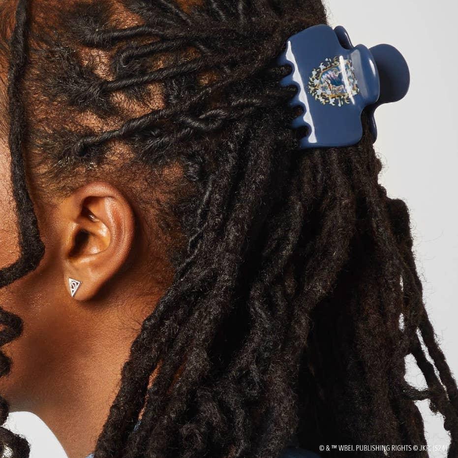 ravenclaw claw clip in a girl's hair, holding her hair back. 