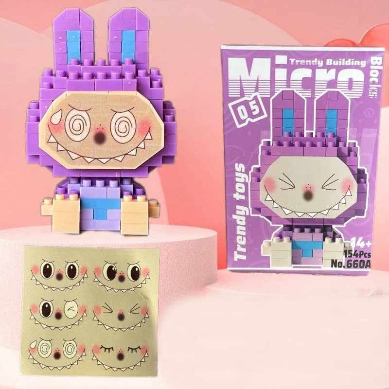 Toy figure made of interlocking bricks with a box labeled 'Trendy Building Micro' on a pink background.