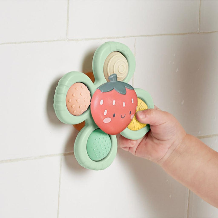 pop and whirl teething toy that can stick to smooth surfaces. 