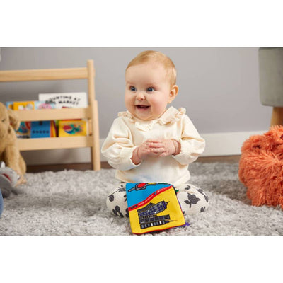 baby posing with the crinkle book